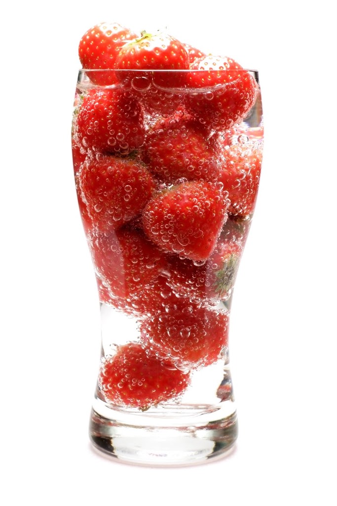 Strawberries in a glass of sparklng water