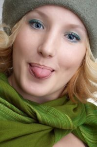 expressing positivity cute blond girl with green scarf portrait (series).