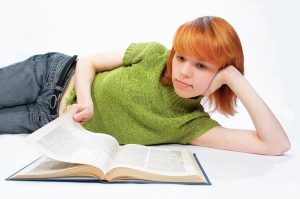 young girl read the book on white